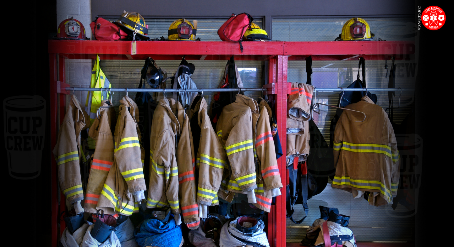 A fire station's firefighting equipment is neatly organized on a red rack, with various fire helmets and jackets hanging on it.