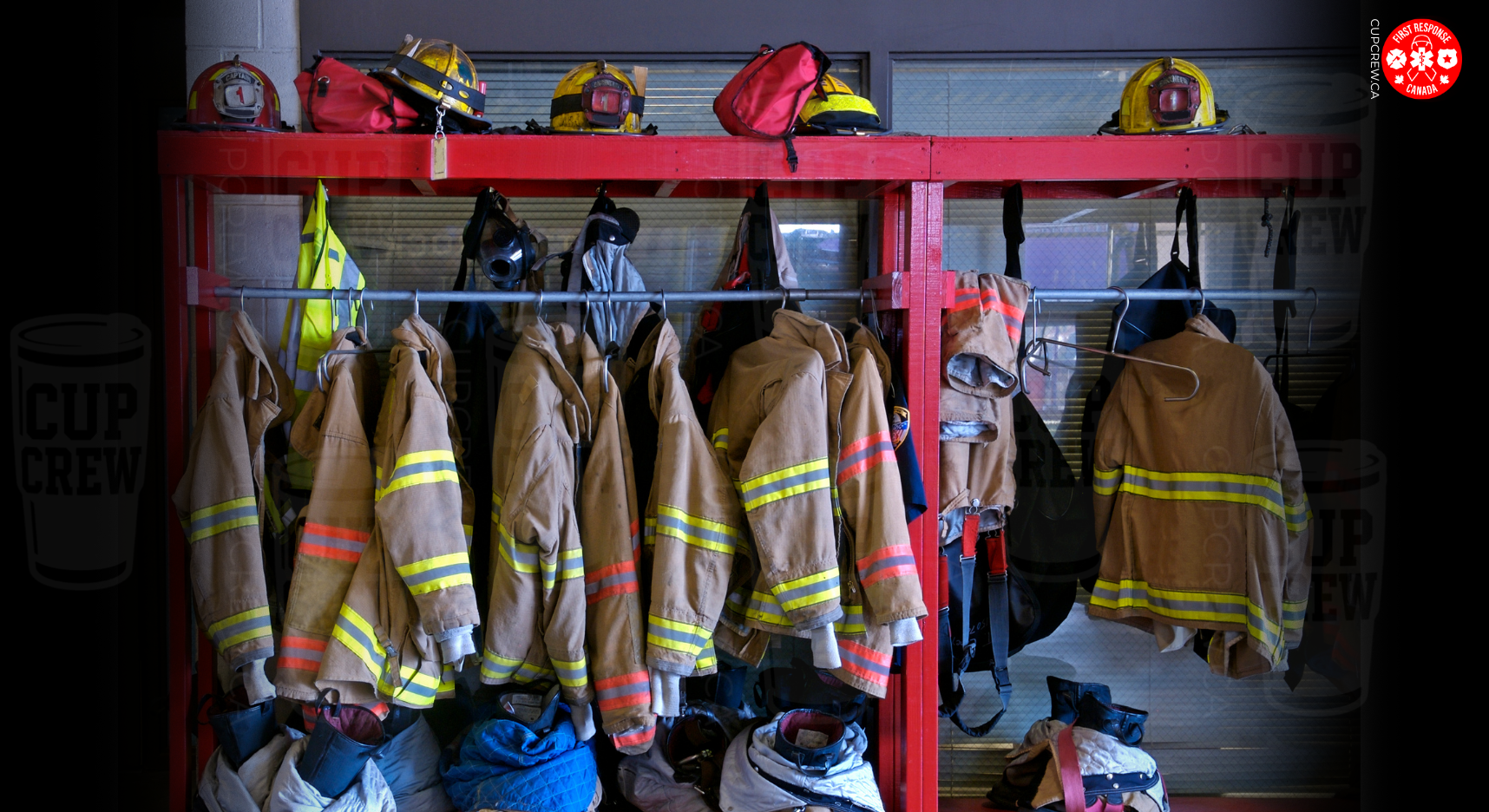 A fire station's firefighting equipment is neatly organized on a red rack, with various fire helmets and jackets hanging on it.